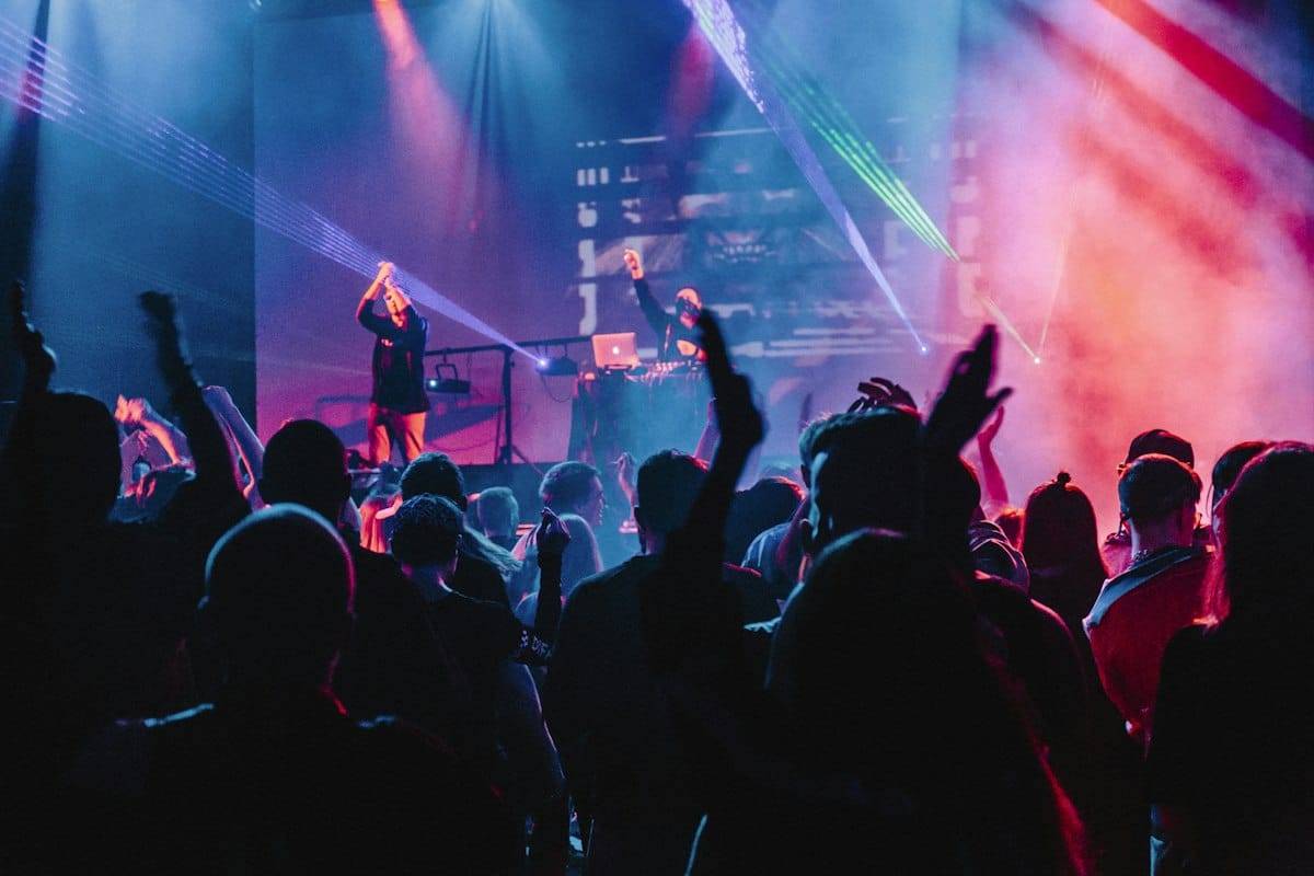 People enjoying nightlife together under colourful lights