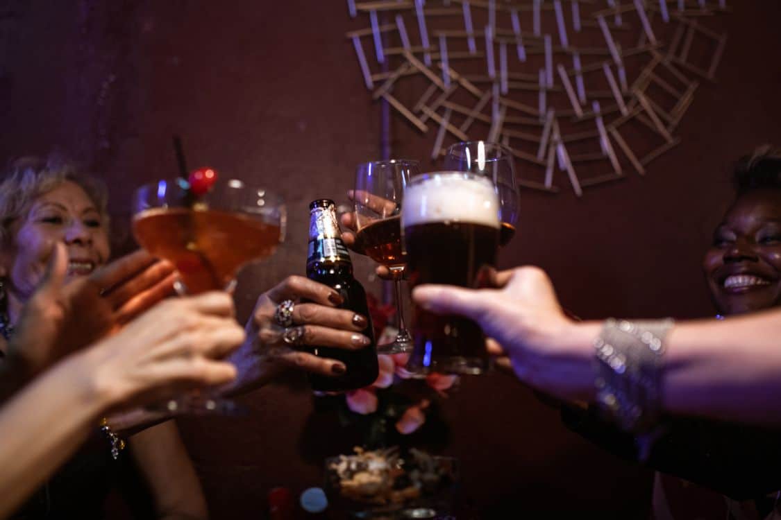 Group of friends raising glasses in a toast during a night out