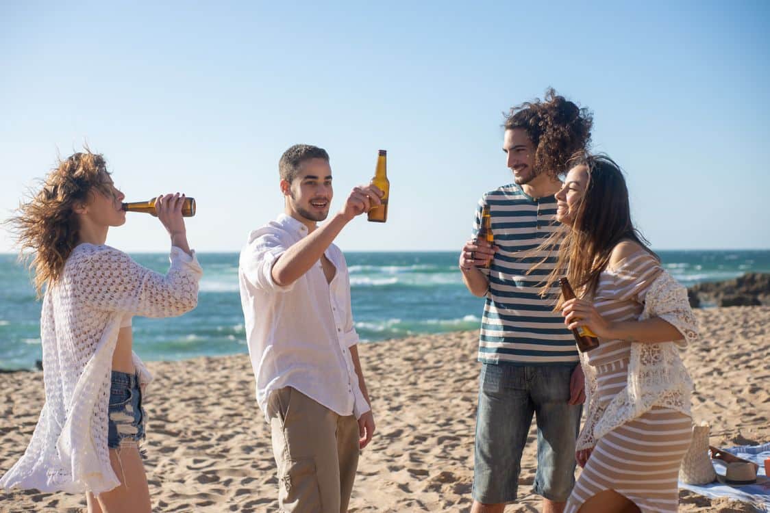Group of friends raising a toast together on a sunny celebration trip abroad
