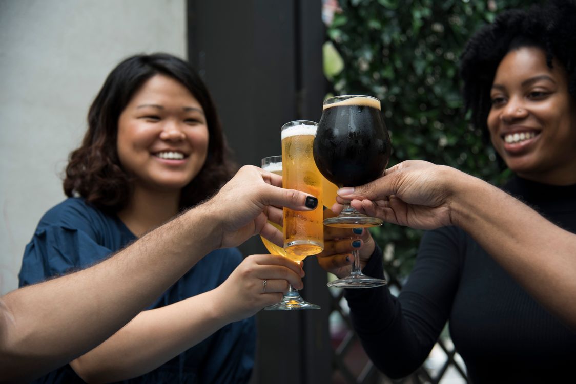 Friends toasting with drinks during an outdoor celebration