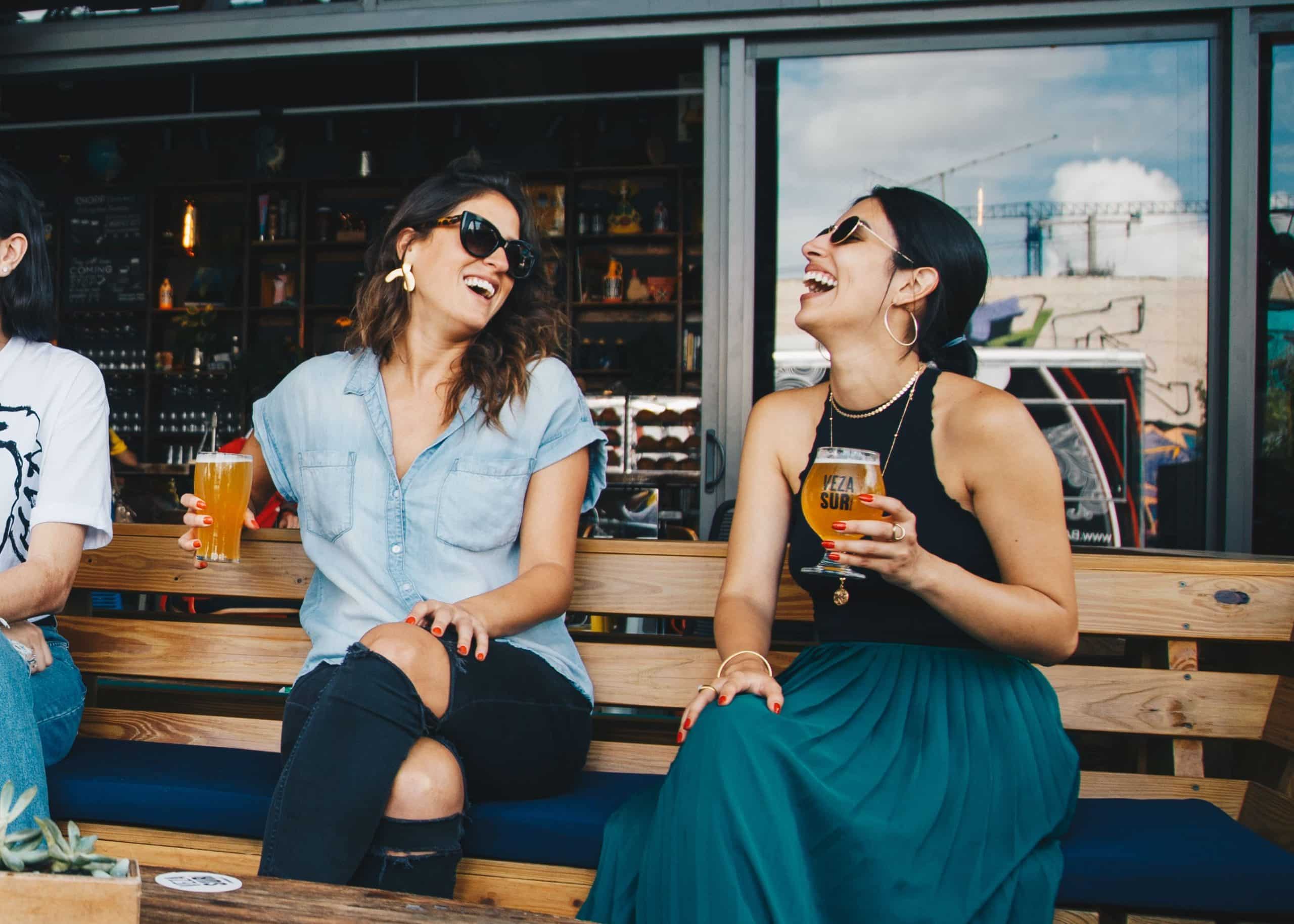 Two friends toasting drinks at a celebration